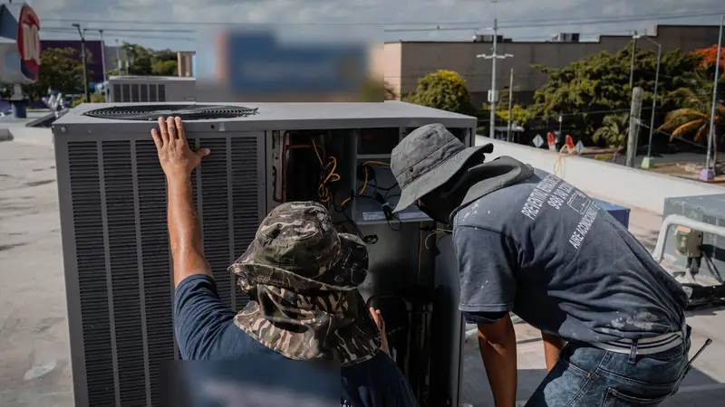 HVAC crew installing a new outdoor unit