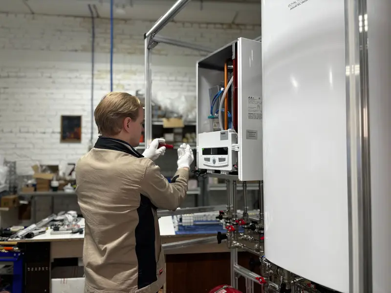 Technician testing a gas furnace with a combustion analyzer