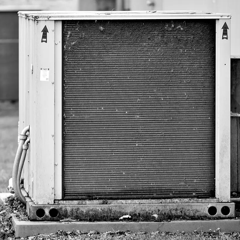 Homeowner photographing the label on an outdoor AC unit