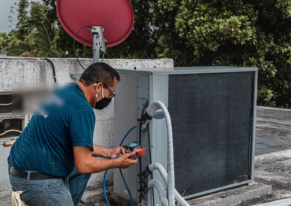 HVAC technician servicing a heat pump at a Raleigh home